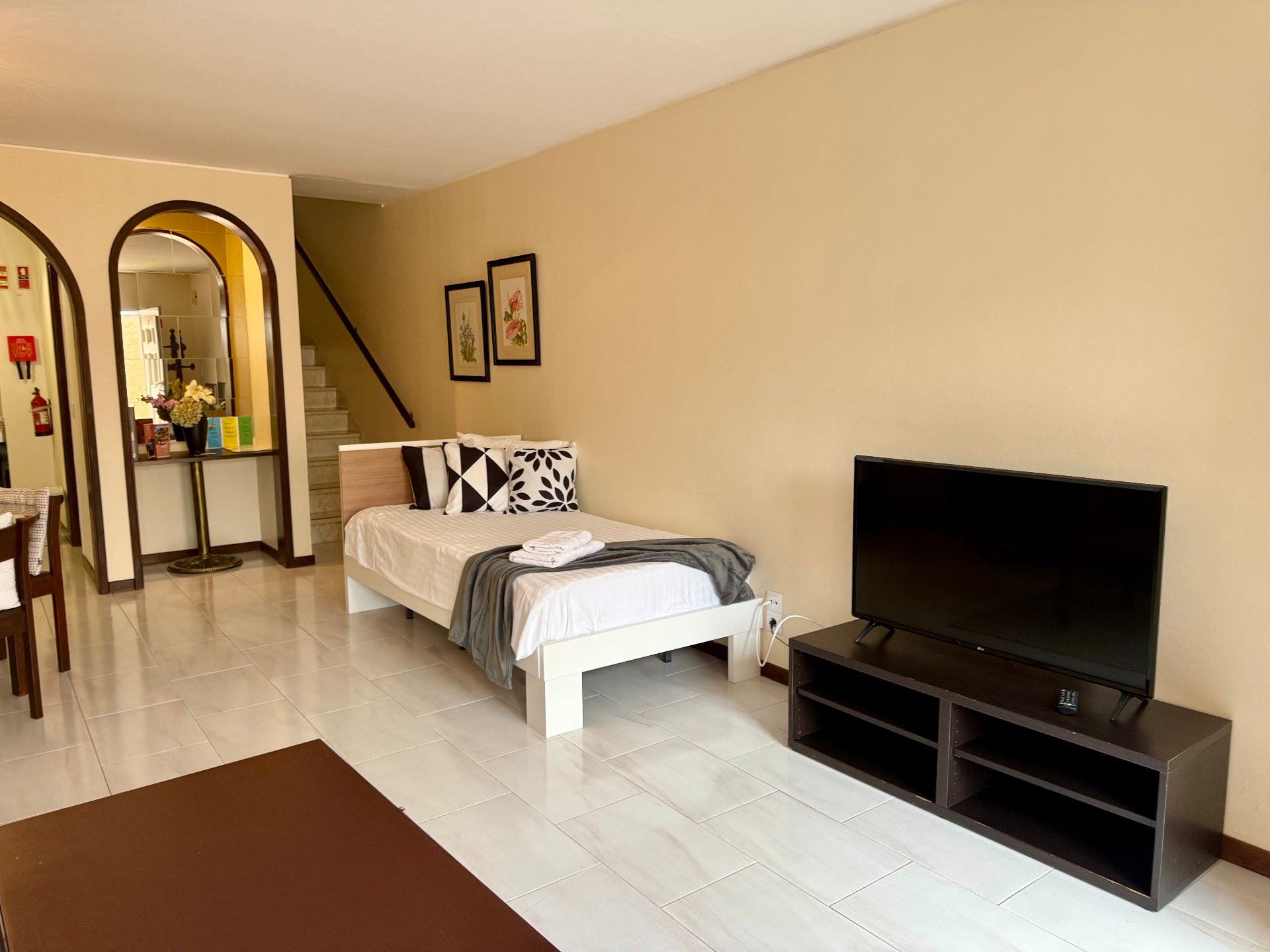 Wide view of a Family Villa living and sleeping area with staircase