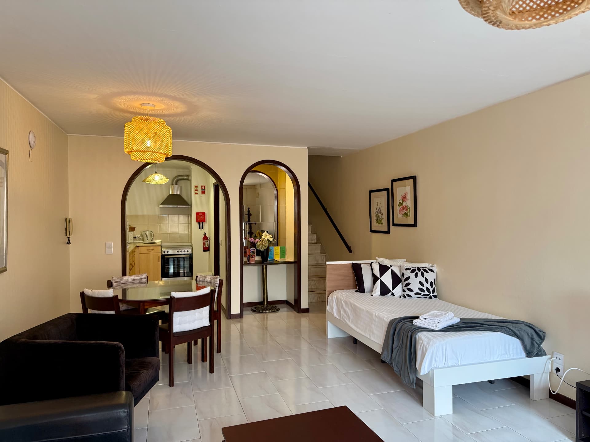 Family Villa dining area beside the single bed, with kitchen through the arch
