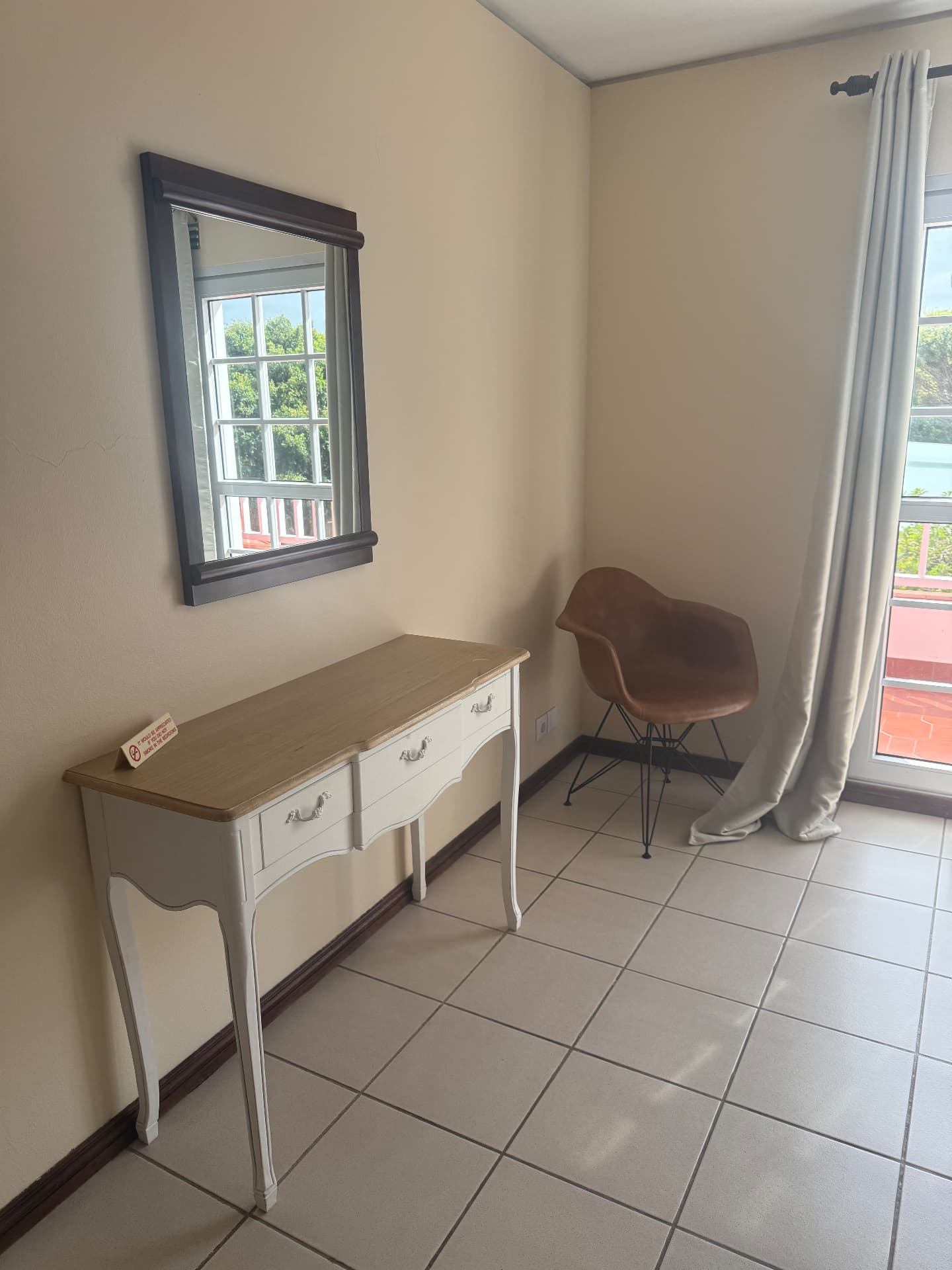Writing desk and armchair beside the balcony in a Classic Villa